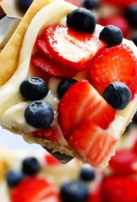 Delicious easy fruit pizza topped with fresh fruits and cream cheese frosting