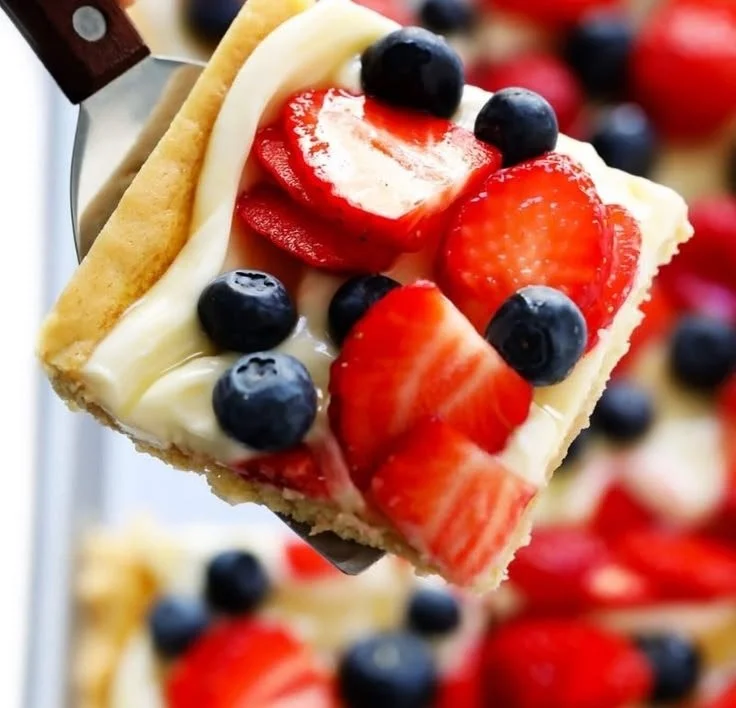 Delicious easy fruit pizza topped with fresh fruits and cream cheese frosting