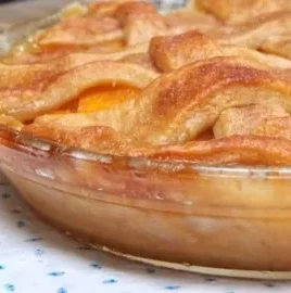 Homemade easy peach cobbler in a baking dish with a golden crust