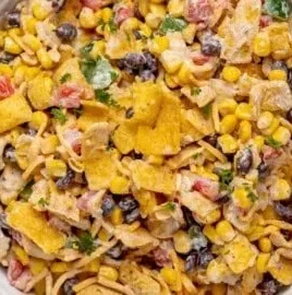 Delicious Frito Corn Salad in a bowl, topped with fresh ingredients