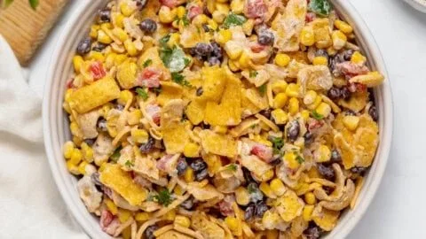 Delicious Frito Corn Salad in a bowl, topped with fresh ingredients