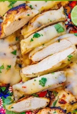 Grilled chicken topped with fresh salsa verde on a plate