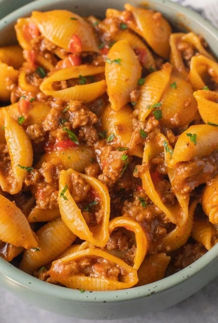 Plate of high protein taco pasta topped with cheese and cilantro