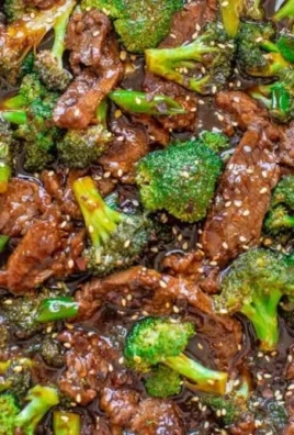 Delicious homemade beef and broccoli served with rice on a plate.