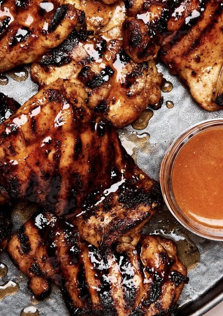 Plate of homemade hot honey chicken garnished with herbs and spices.