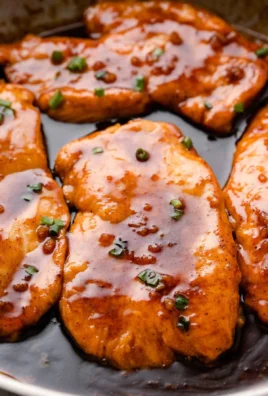 Delicious Honey Garlic Butter Chicken served on a plate with fresh herbs.