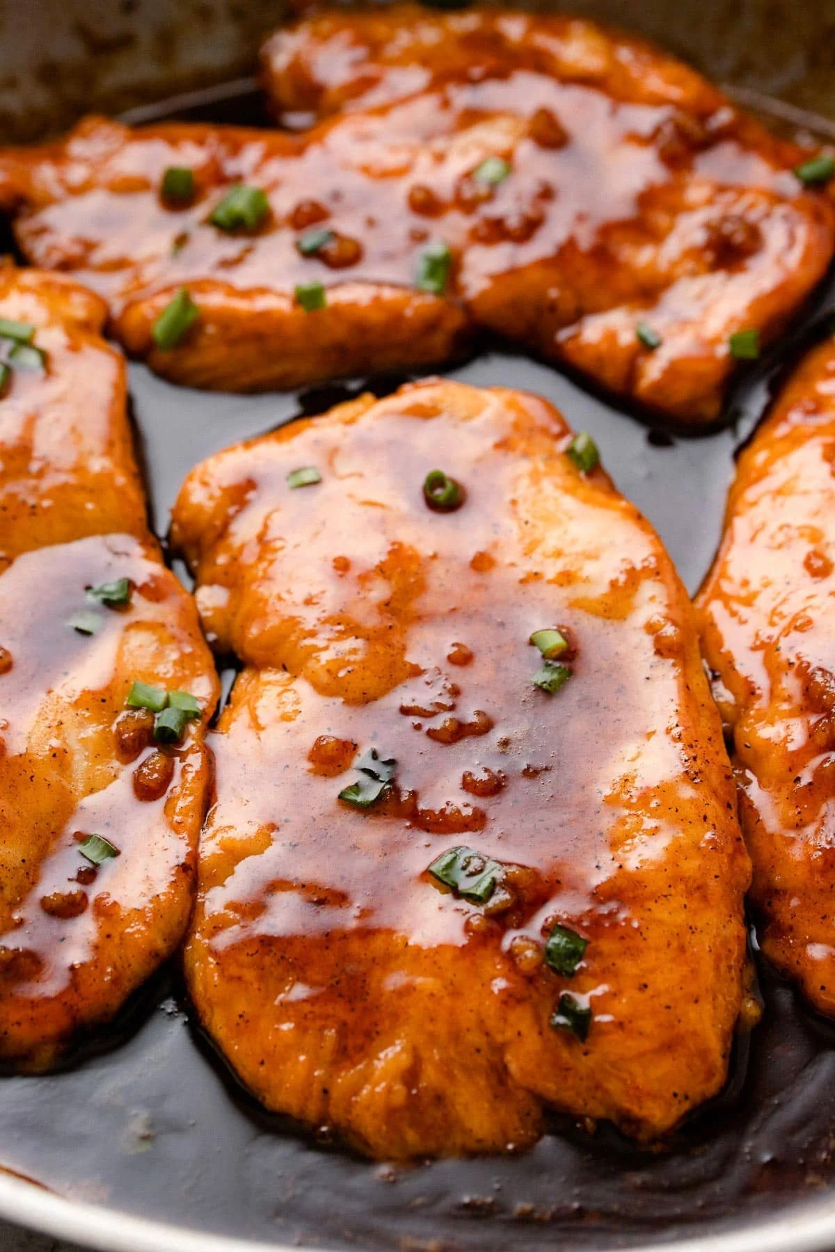 Delicious Honey Garlic Butter Chicken served on a plate with fresh herbs.
