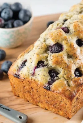 Lemon blueberry poppy seed loaf served on a wooden cutting board