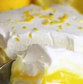 Delicious Lemon Lush dessert served in a glass with a lemon garnish