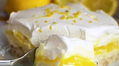 Delicious Lemon Lush dessert served in a glass with a lemon garnish