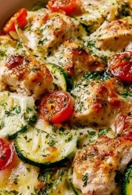 Mediterranean chicken zucchini bake fresh out of the oven, garnished with herbs.