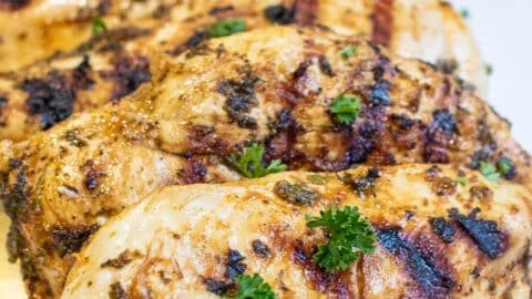 Mediterranean grilled chicken breasts served with herbs and vegetables