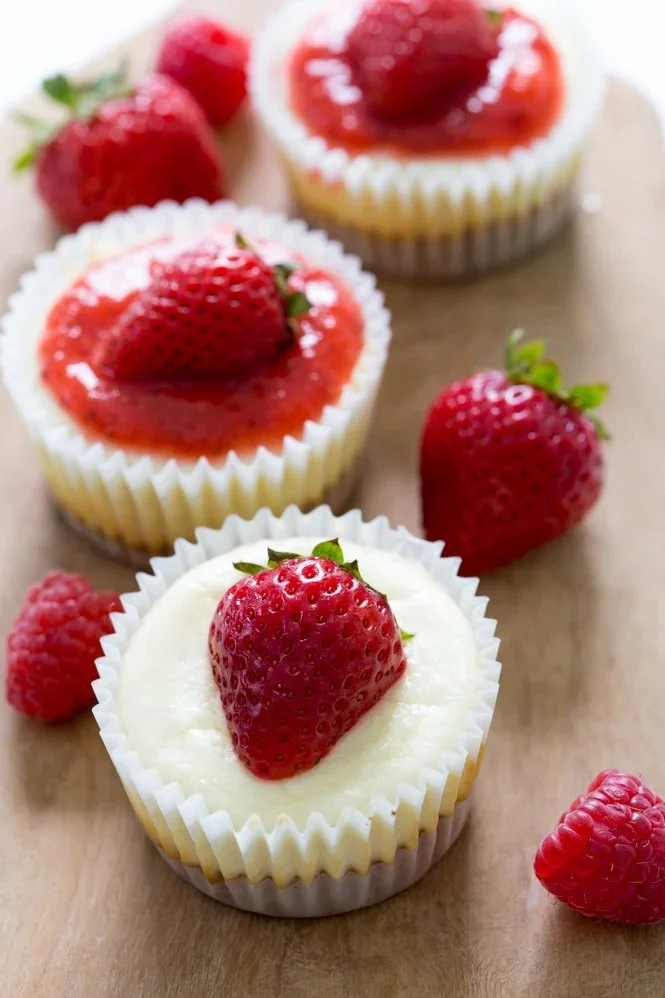 Delicious mini cheesecake cupcakes topped with creamy frosting.
