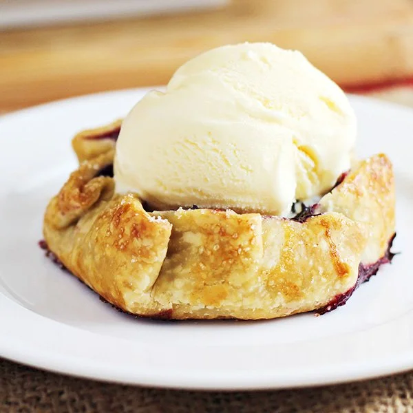 Mini summer berry galettes fresh out of the oven, showcasing vibrant berries.