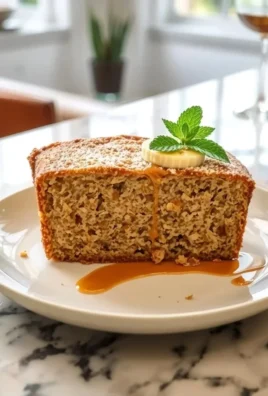 Sliced moist banana bread on a wooden cutting board with bananas and walnuts