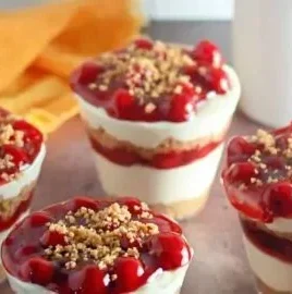 Delicious no-bake cheesecake parfait layered with graham cracker crumbs and berries