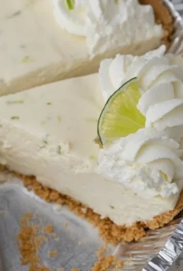 No Bake Key Lime Pie topped with whipped cream and lime slices