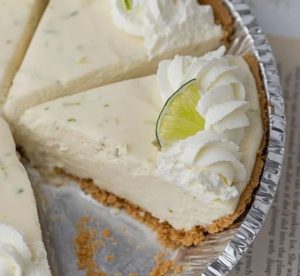 No Bake Key Lime Pie topped with whipped cream and lime slices