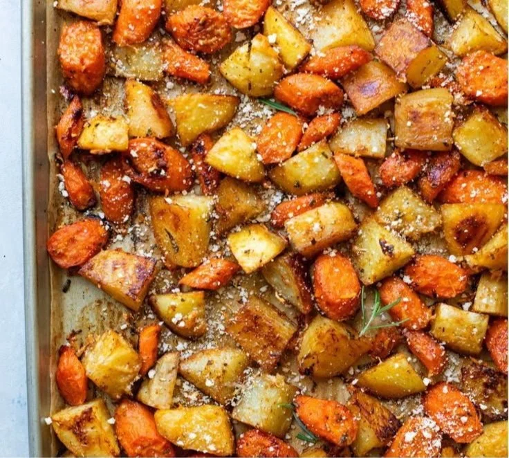 Oven roasted carrots and potatoes served on a platter, garnished and ready to eat.