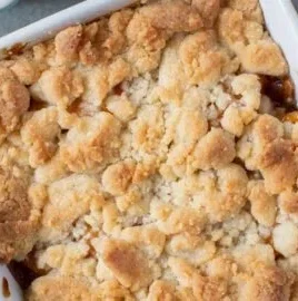 Delicious peach cobbler for two served in an elegant dish.