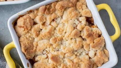 Delicious peach cobbler for two served in an elegant dish.