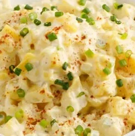 Delicious homemade potato salad served in a bowl with fresh herbs