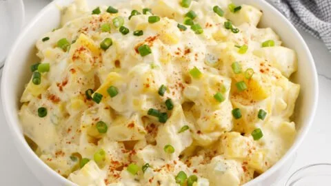Delicious homemade potato salad served in a bowl with fresh herbs