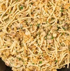 Sardine pasta with lemon and garlic crumbs served in a bowl.