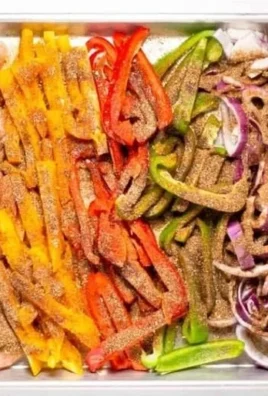 Sheet pan chicken fajitas with colorful peppers and onions ready to serve.