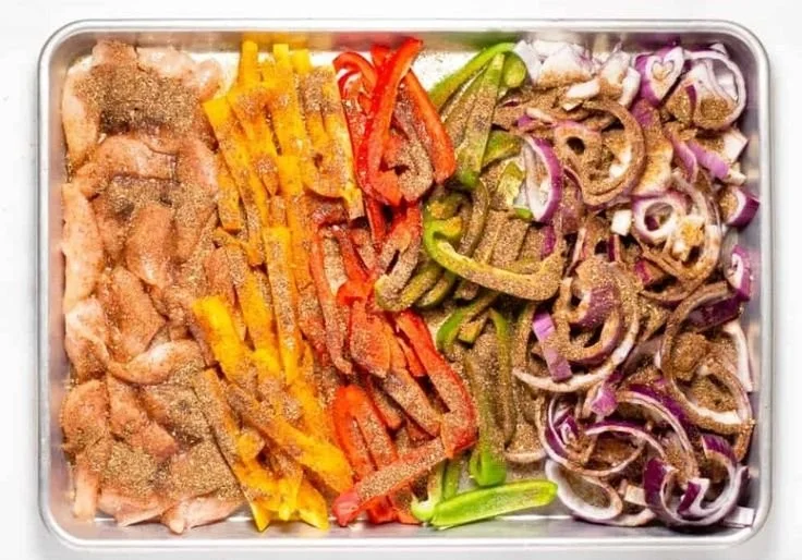 Sheet pan chicken fajitas with colorful peppers and onions ready to serve.