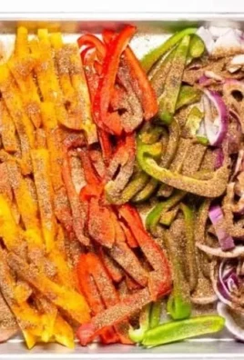 Sheet pan chicken fajitas with colorful peppers and onions cooked to perfection