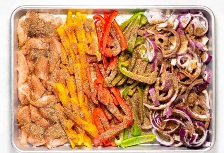 Sheet pan chicken fajitas with colorful peppers and onions cooked to perfection