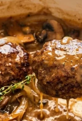 Plate of Southern Hamburger Steak topped with onion and mushroom gravy