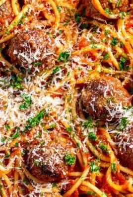 Delicious spaghetti meatball dish served with marinara sauce and fresh herbs