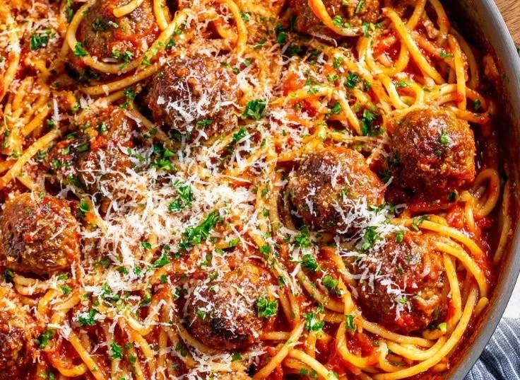 Delicious spaghetti meatball dish served with marinara sauce and fresh herbs