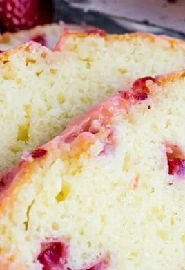 Delicious slice of homemade Strawberry Pound Cake topped with fresh strawberries