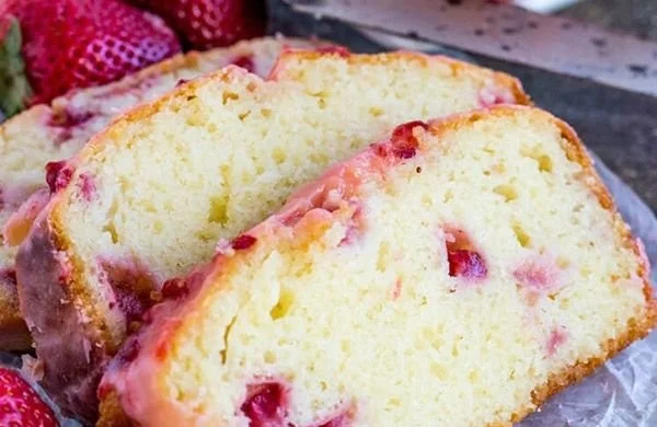 Delicious slice of homemade Strawberry Pound Cake topped with fresh strawberries