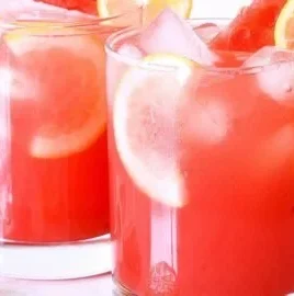 Refreshing watermelon lemonade in a glass with ice and lemon slices